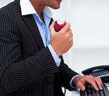 Close-up of a businessman eating a fruit