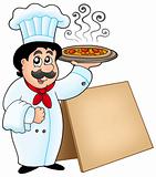 Chef holding pizza with table