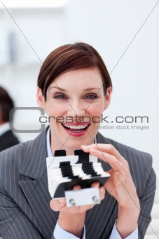 Smiling businesswoman holding a card holder