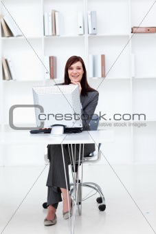 High angle of a smiling businesswoman working at a computer