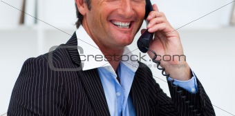 Close-up of a smiling businessman talking on phone 