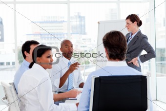 Serious manager giving presentation to her team