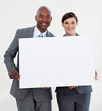 Smiling business people holding white card 