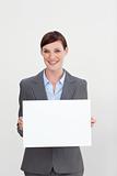Confident businesswoman holding white card