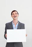 Laughing businesswoman holding white card 