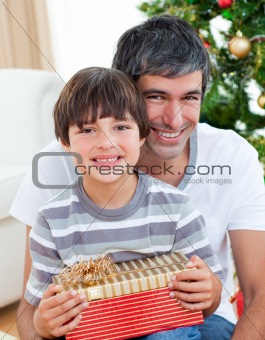 Father and son holding a Christmas gift