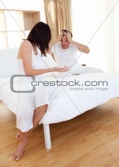 Couple in bedroom having an argument 