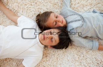 Siblings sleeping on the floor