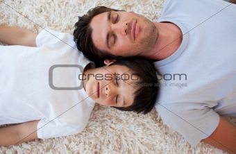 Father and his son sleeping on the floor