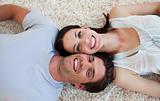 Smiling Couple lying on the floor
