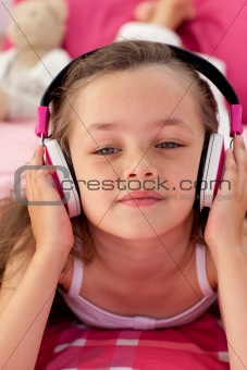 Close-up of a little girl listening musc