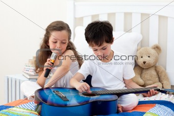 Siblings singing and playing guitar