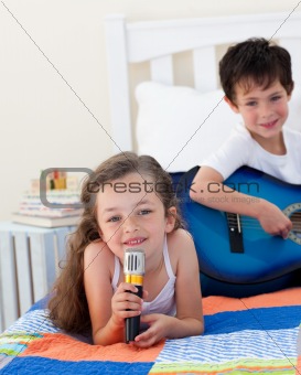 Happy children in child's room on a bed