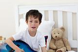 Little boy singing and playing guitar