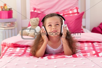 Cute girl listening music in the bedroom