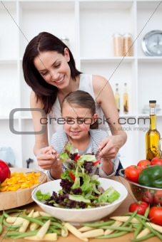 Little girl cooking with her mother
