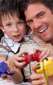 Portrait of a happy father and his son playing video games