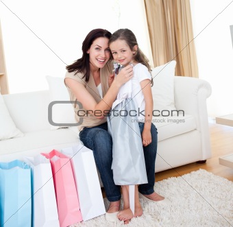 Happy mother and little girl after shopping 