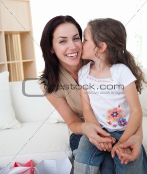 Little girl kissing her mother