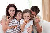 Smiling family eating pizza 