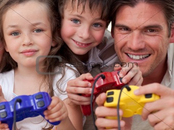 Happy father and his children playing video games