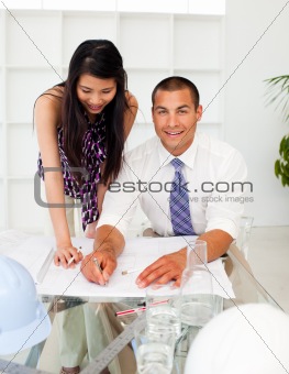 Portrait of architects studying plans in a meeting