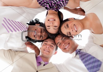 Smiling business team in a circle with heads together