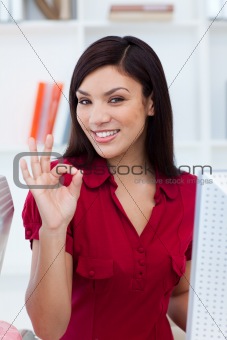 Ethnic businesswoman showing OK sign