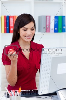 Smiling businesswoman holding a red apple