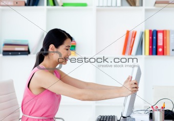 Attractive businesswoman getting frustrated with a computer