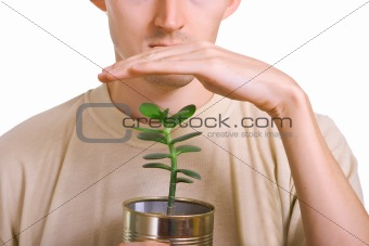 men holding and preserves a young plant