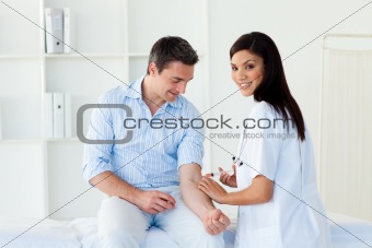 Smiling female doctor giving vaccine to a patient