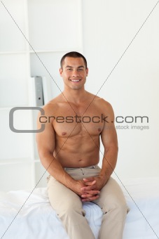 Smiling patient sitting on hospital bed