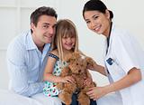 Doctor examining smiling child and father