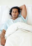 Male patient sleeping in a hospital bed