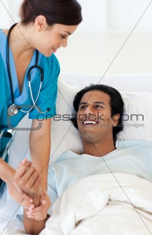 A doctor examining a patient lying on a hospital bed