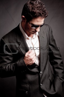 Young business man looking down wearing sunglasses