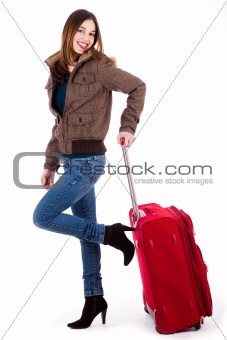 Young women ready for travel posing with her luggage