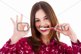 Women brushing her teeth and showing perfect gesture