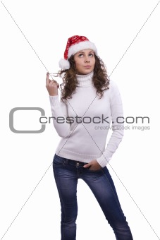 Santa girl in red Christmas cap is thinking about something
