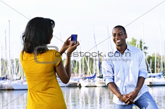 Man posing for picture near boats