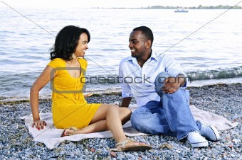 Happy couple sitting at beach