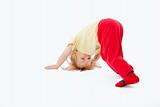 boy with long blond hair trying to stand on his head