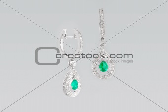 Two silver earrings with diamonds