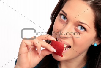Beautiful young girl taking a bite of an apple.
