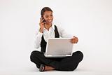Young Woman Using Laptop and Cell Phone