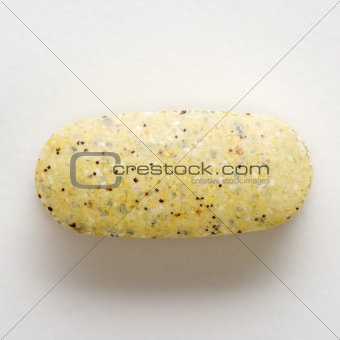 Vitamin tablet on white