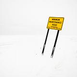 Road sign in blizzard.