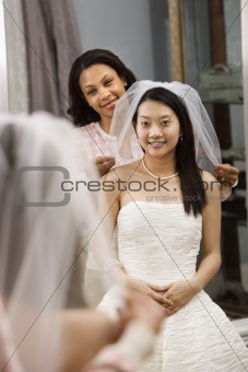Friend helping bride.