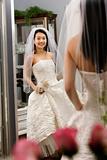 Bride admiring dress. 